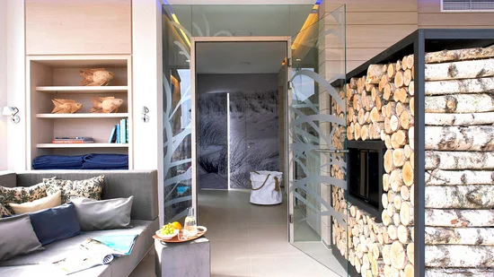 Modern living space with wood décor, glass sliding door, and cozy seating area